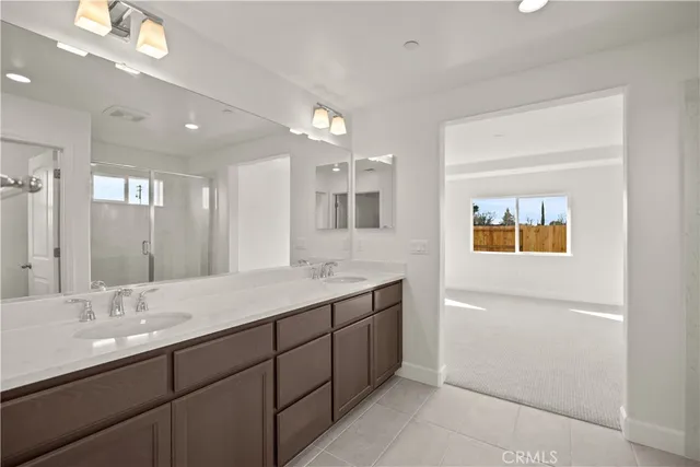 a bathroom with a double vanity sink and a mirror