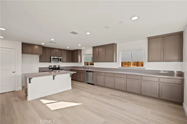a kitchen with a sink stainless steel appliances and cabinets