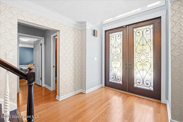 a kitchen with stainless steel appliances kitchen island granite countertop a sink dishwasher stove and refrigerator with wooden floor