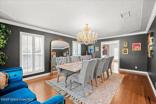 a large white kitchen with granite countertop a stove and a sink with dishwasher next to a large window