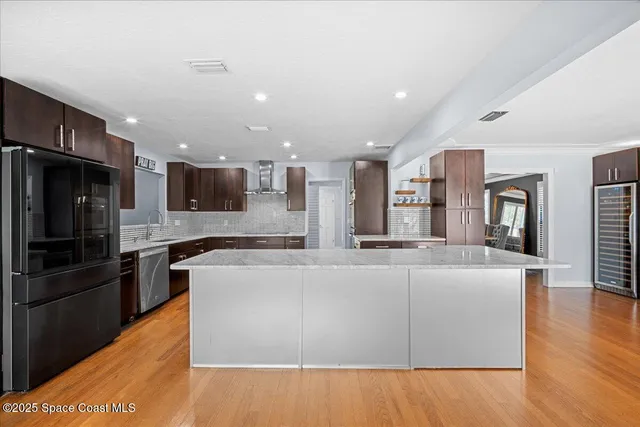 a kitchen with stainless steel appliances granite countertop a refrigerator and a sink