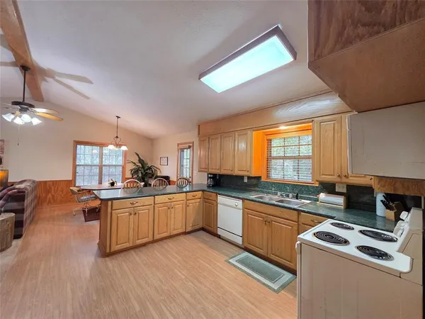 a kitchen with stainless steel appliances granite countertop a stove and a sink