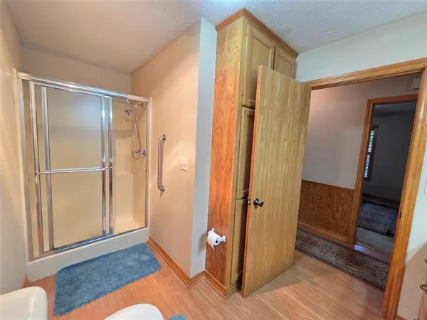 a view of a bathroom with wooden floor and bathroom