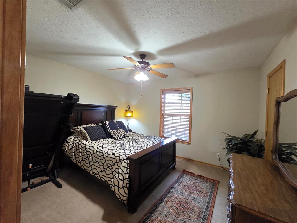 5015 561st Road Simms, TX 75574 - Photo 18 of 33 a bedroom with a bed and a window