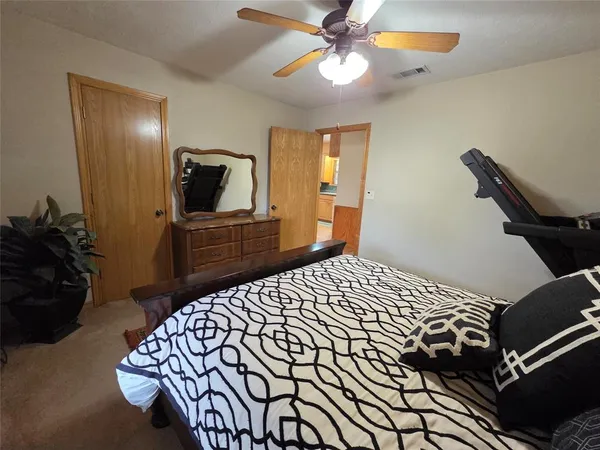 a bedroom with a bed and a mirror