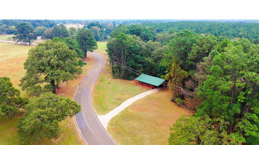 5015 561st Road Simms, TX 75574 - Photo 30 of 33 a view of a swimming pool with a yard and large trees