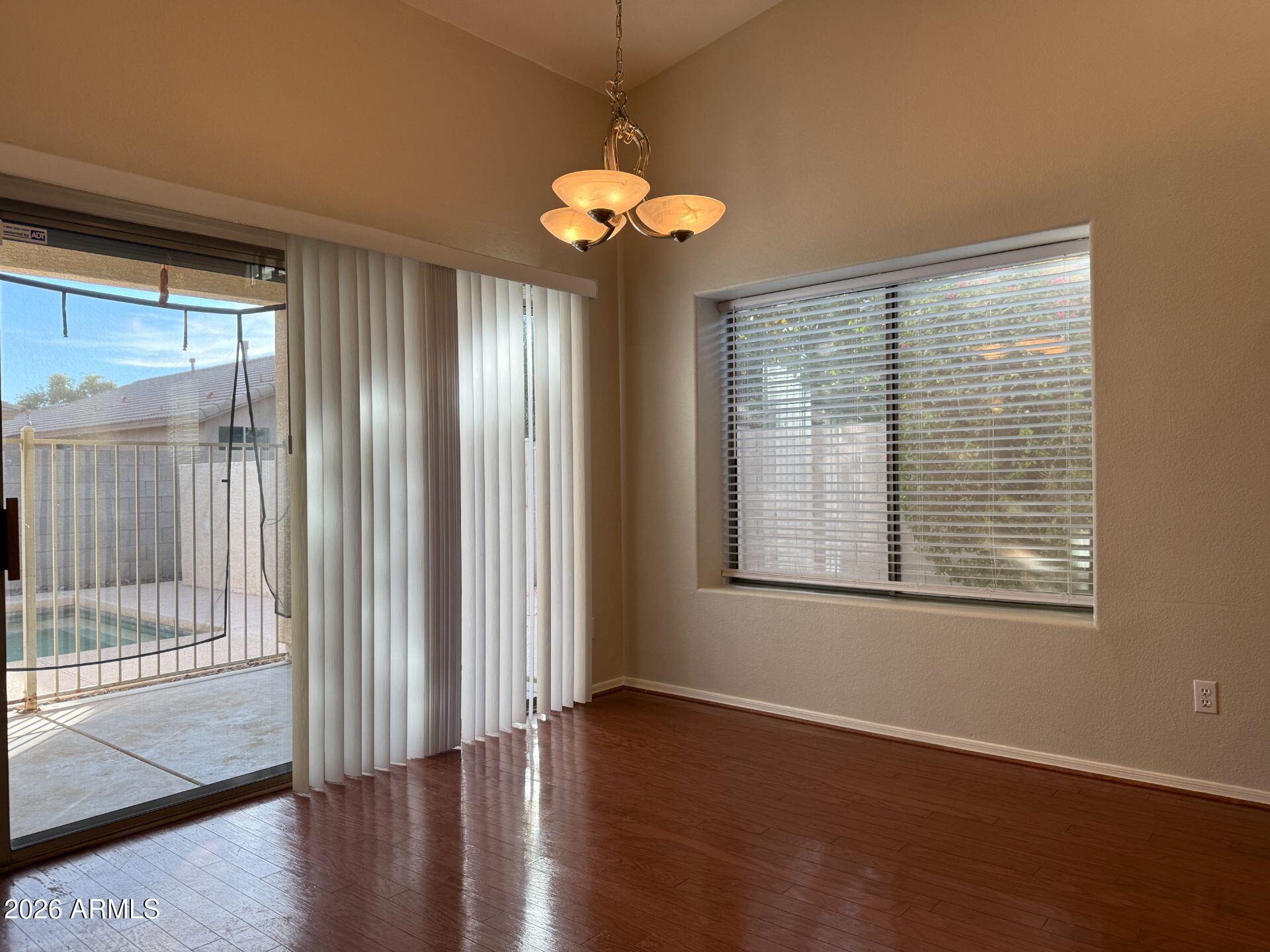 14641 West Hearn Road Surprise, AZ 85379 - Photo 15 of 42 a view of an empty room with wooden floor and a window