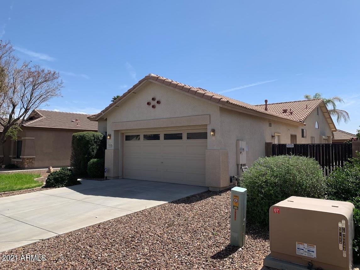 14641 West Hearn Road Surprise, AZ 85379 - Photo 2 of 42 a front view of a house with a yard and garage