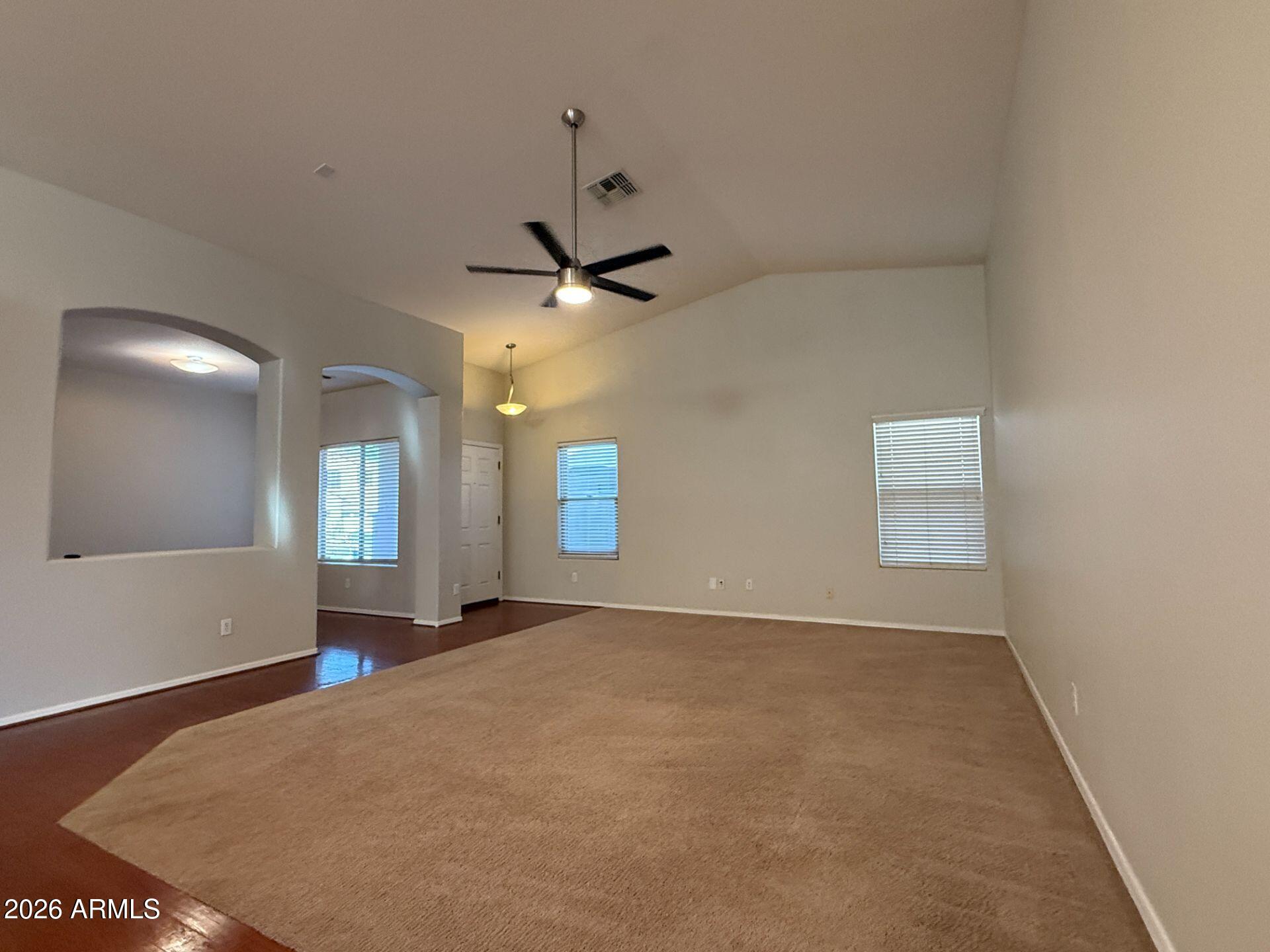 14641 West Hearn Road Surprise, AZ 85379 - Photo 3 of 42 an empty room with windows and fan