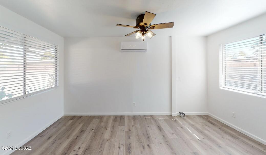 2118 North Rita Avenue Tucson, AZ 85716 - Photo 5 of 17 wooden floor in an empty room with a window