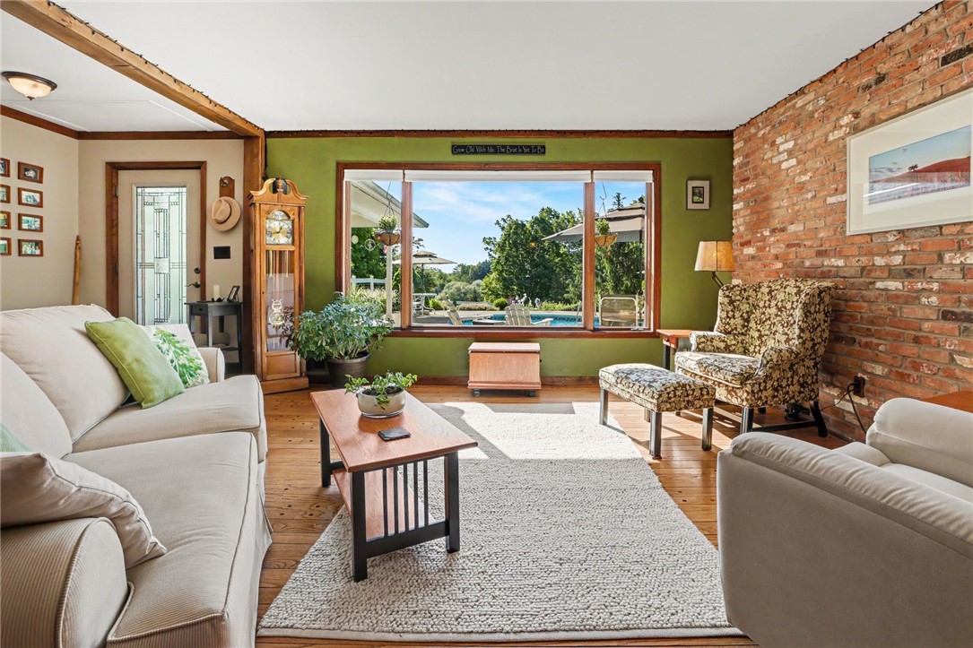 1722 Strong Road Victor, NY 14564 - Photo 4 of 33 Front room features hardwood floors, brick accent