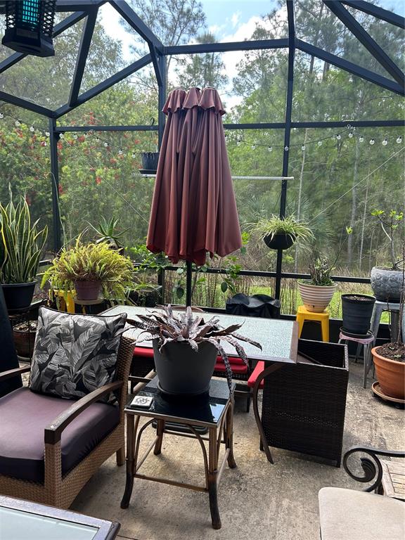 377 Vestrella Drive Kissimmee, FL 34759 - Photo 12 of 12 a patio with a yard a table and chairs