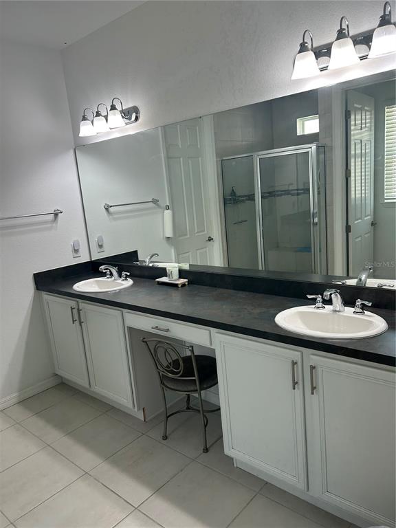 377 Vestrella Drive Kissimmee, FL 34759 - Photo 6 of 12 a bathroom with a sink and a mirror