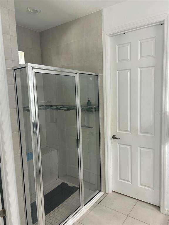 377 Vestrella Drive Kissimmee, FL 34759 - Photo 7 of 12 a bathroom with a glass shower door