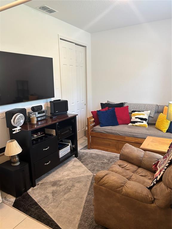 377 Vestrella Drive Kissimmee, FL 34759 - Photo 10 of 12 a living room with a couch and a flat screen tv
