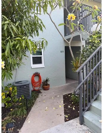 a kitchen with granite countertop a refrigerator and a stove top oven