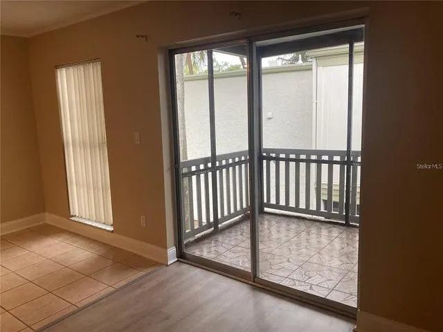 a view of a small space with wooden floor and fan