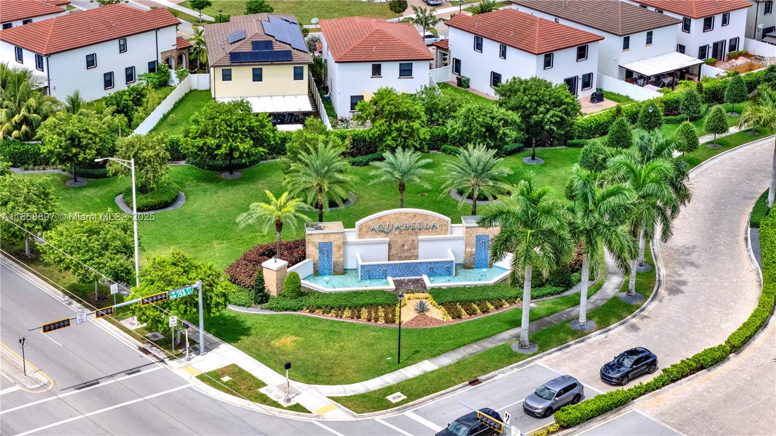 a view of a multi story residential apartment building with a yard and plants