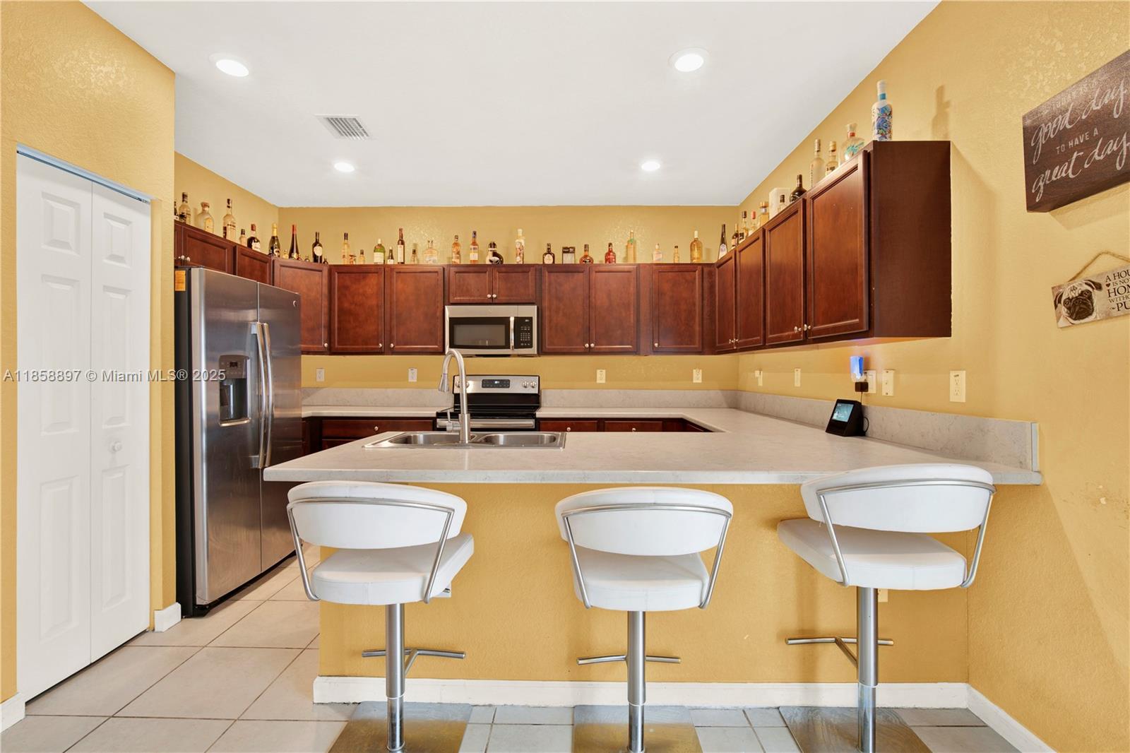 10480 West 33rd Lane Hialeah, FL 33018 - Photo 14 of 53 a kitchen with a dining table chairs and refrigerator