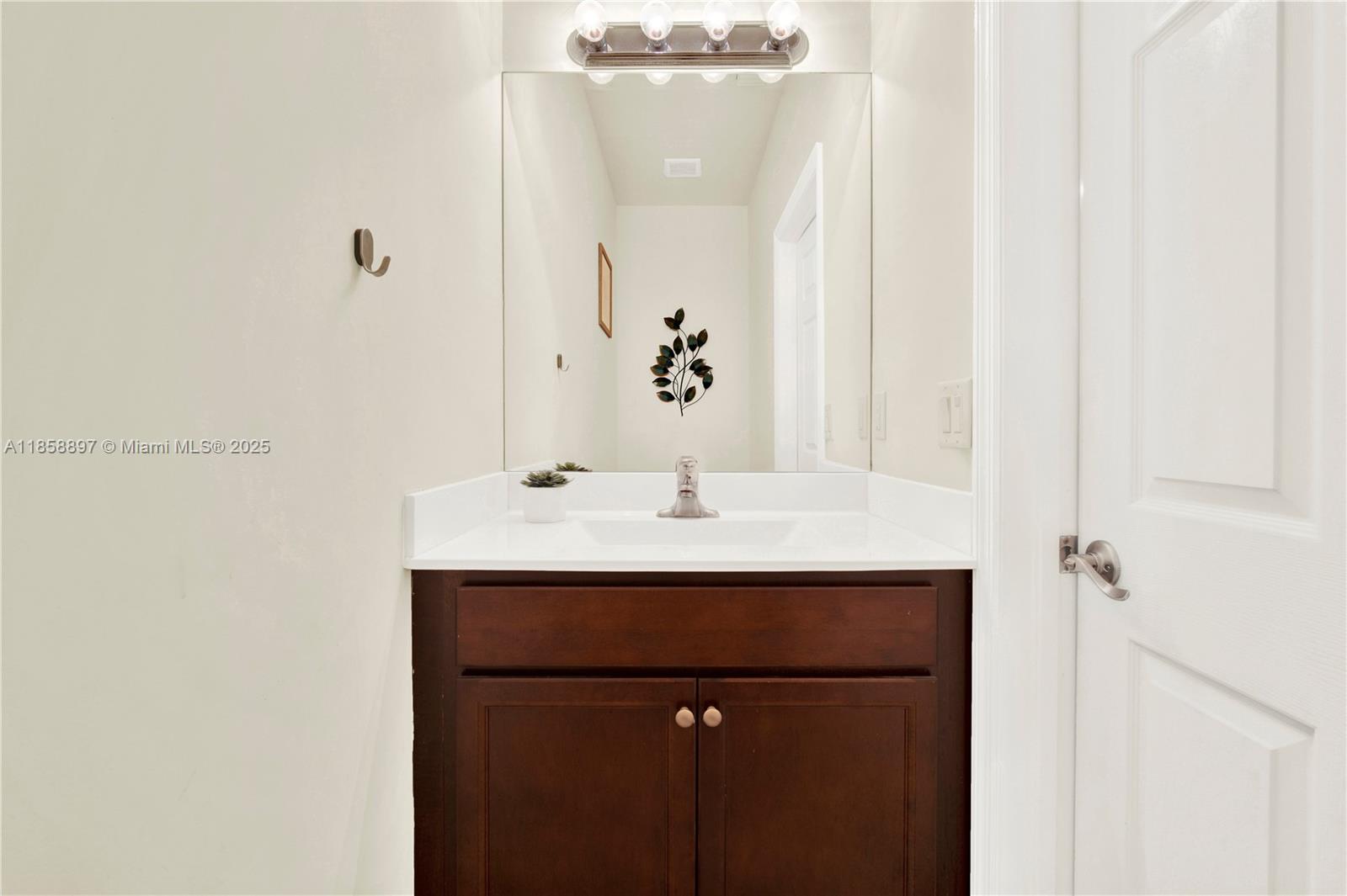 10480 West 33rd Lane Hialeah, FL 33018 - Photo 16 of 53 a bathroom with a sink and a mirror