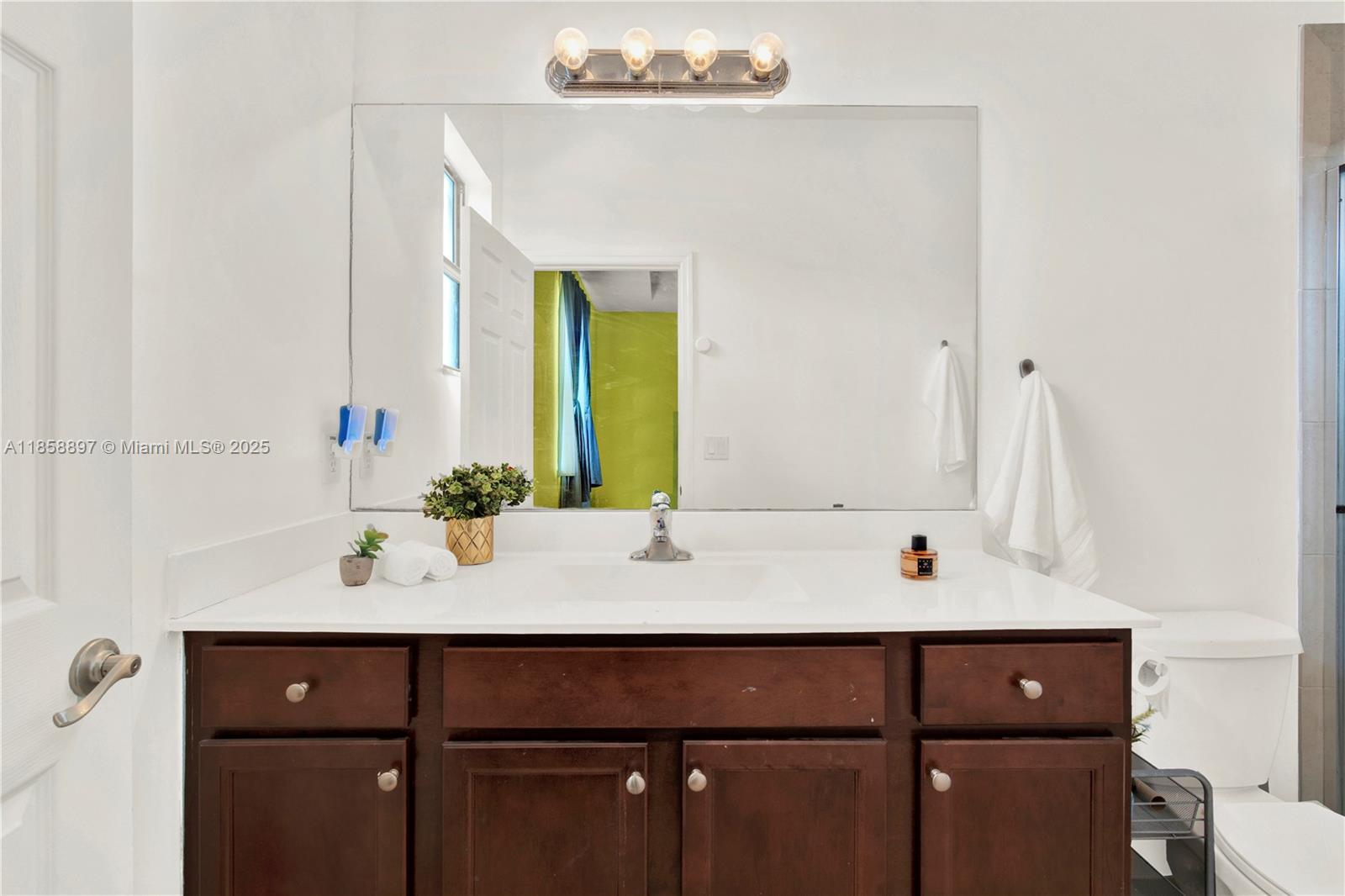 10480 West 33rd Lane Hialeah, FL 33018 - Photo 22 of 53 a bathroom with a sink and a mirror