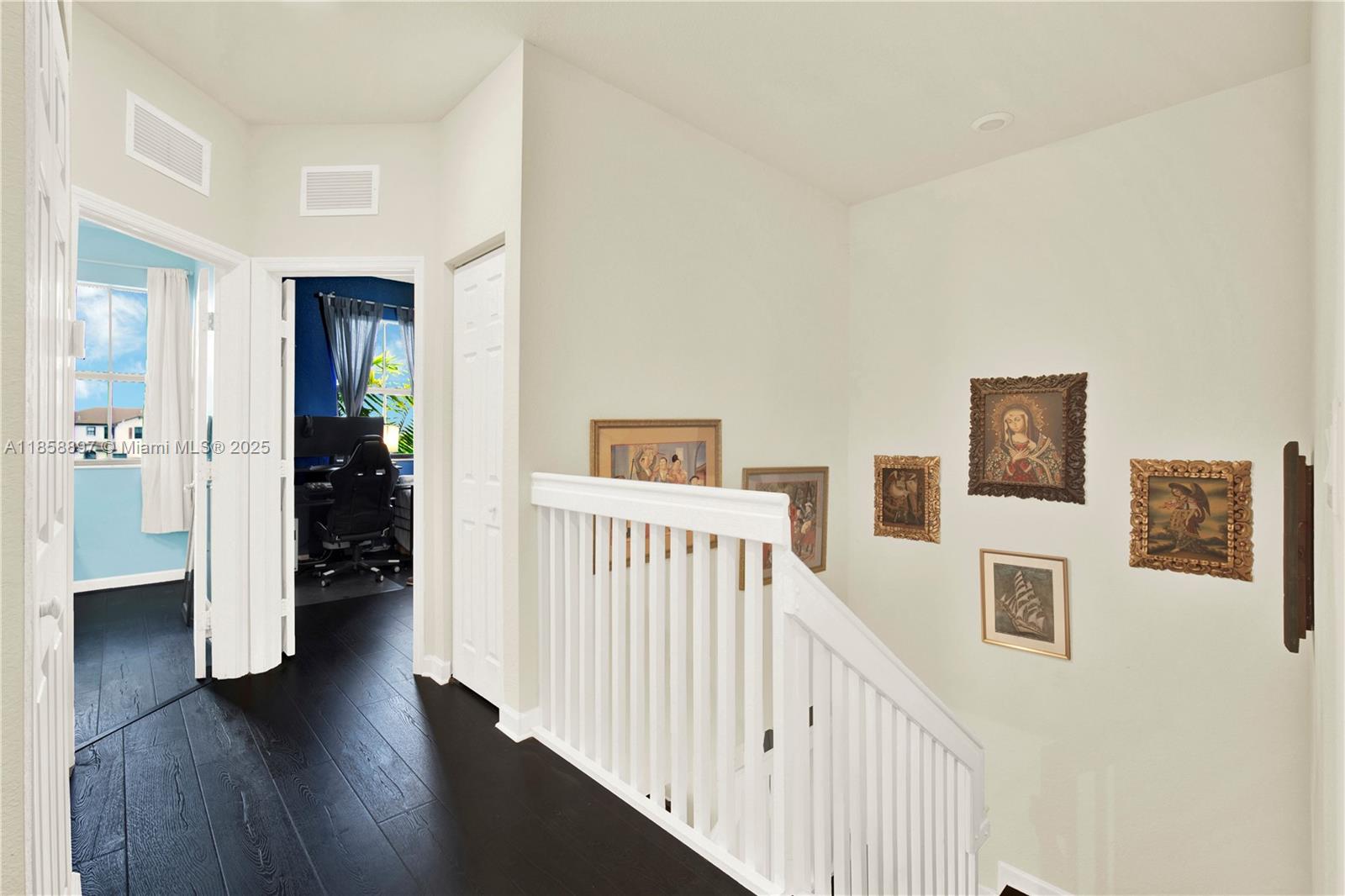 10480 West 33rd Lane Hialeah, FL 33018 - Photo 23 of 53 a view of a hallway with wooden floor and a living room