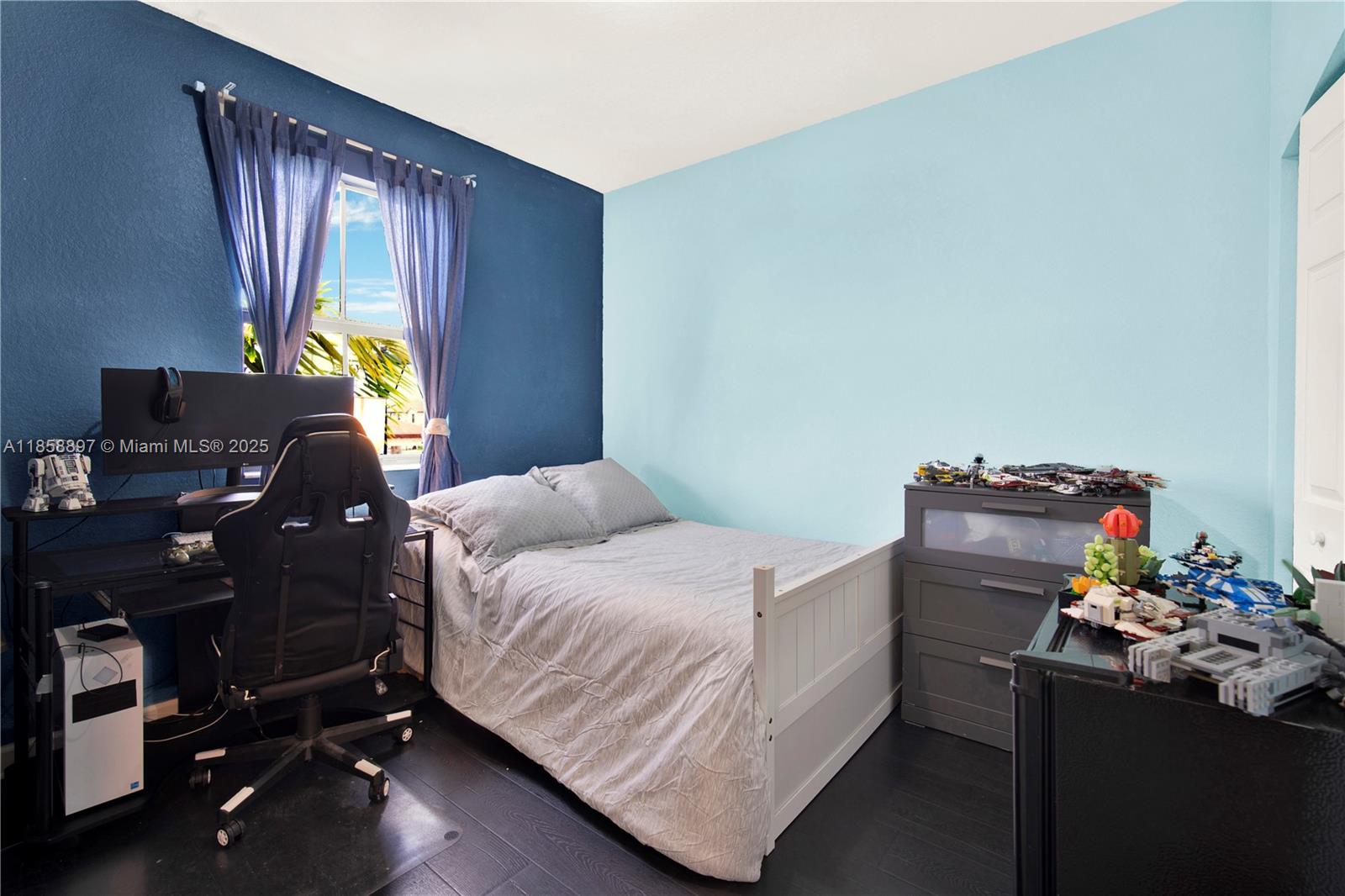 10480 West 33rd Lane Hialeah, FL 33018 - Photo 25 of 53 a bedroom with a bed and a window