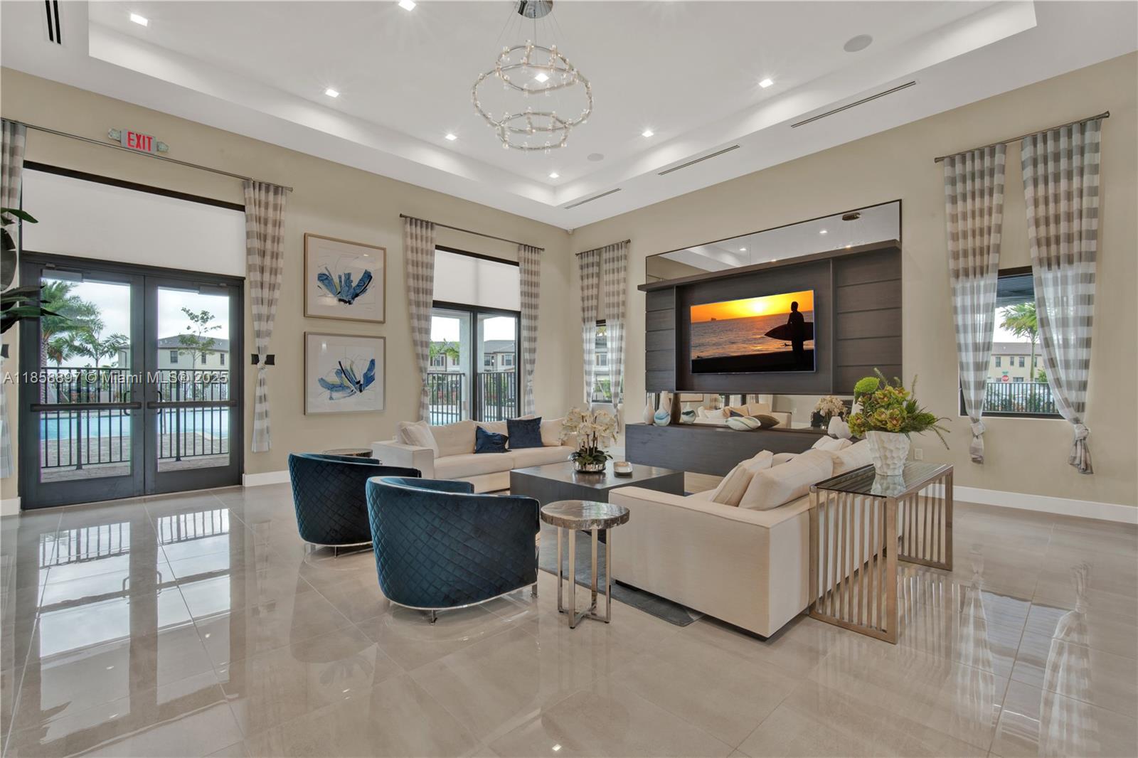 10480 West 33rd Lane Hialeah, FL 33018 - Photo 42 of 53 a living room with furniture a flat screen tv and a floor to ceiling window