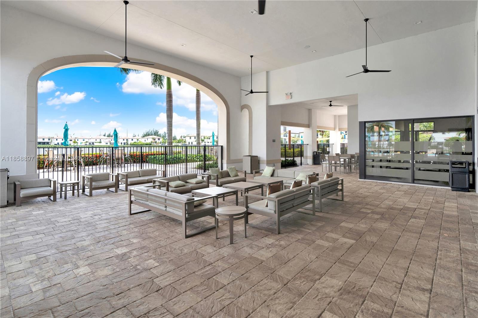 10480 West 33rd Lane Hialeah, FL 33018 - Photo 52 of 53 a living room with couches and a dining table with chandelier