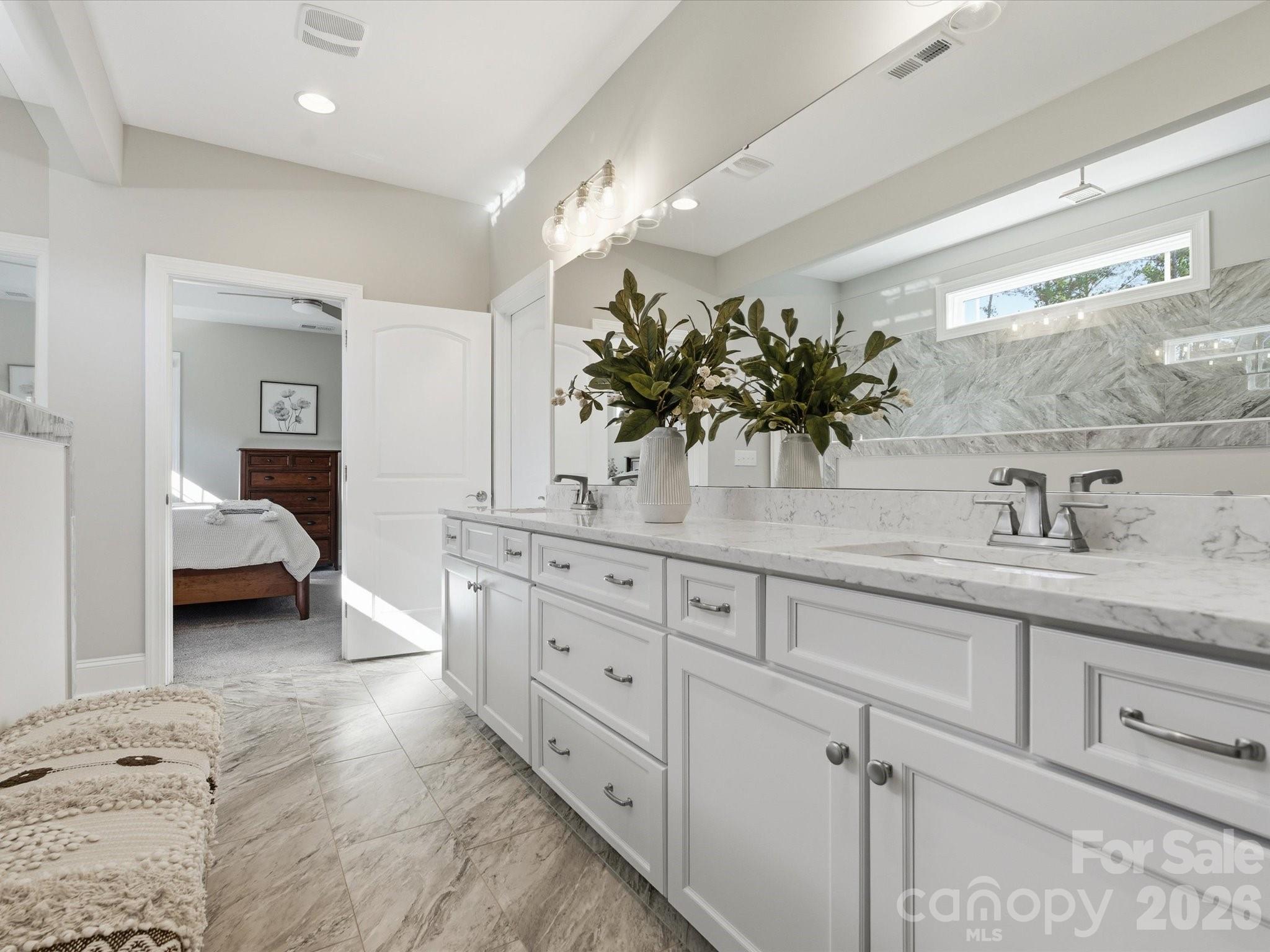4166 Persimmon Road Lancaster, SC 29720 - Photo 20 of 41 a en suite bathroom with double sink and a mirror