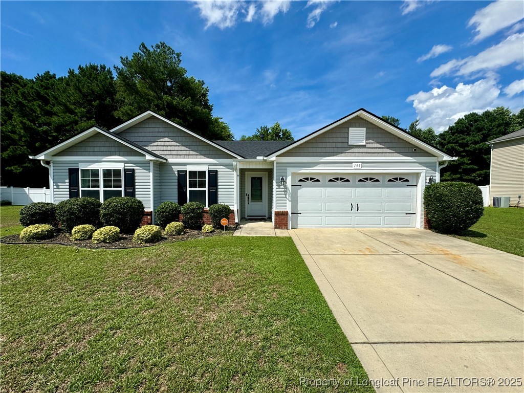193 Bayleaf Drive Raeford, NC 28376 - Photo 2 of 25 a front view of a house with a yard and garage
