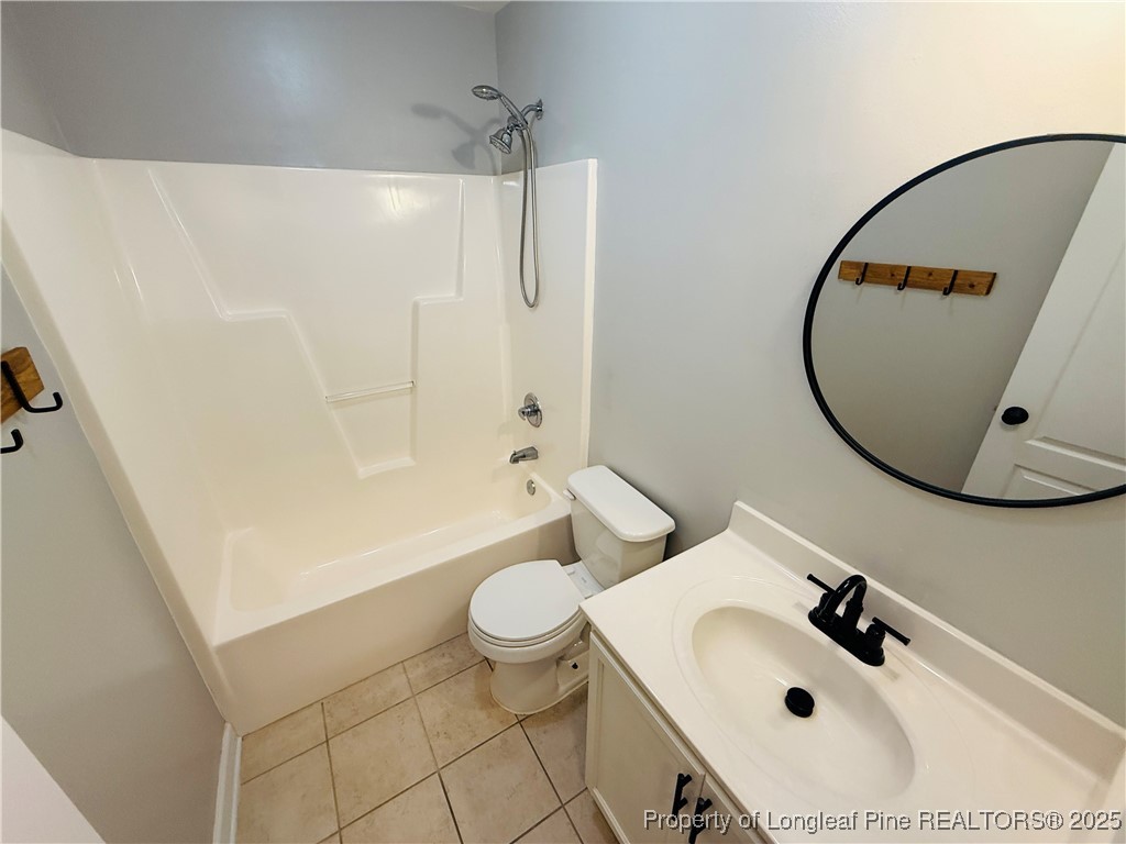 193 Bayleaf Drive Raeford, NC 28376 - Photo 22 of 25 a bathroom with a sink a toilet and a mirror