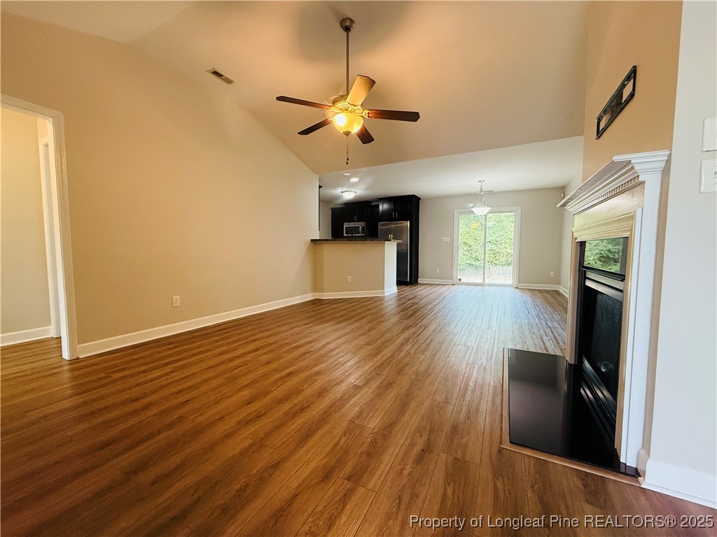 193 Bayleaf Drive Raeford, NC 28376 - Photo 4 of 25 a view of an empty room with wooden floor and a window