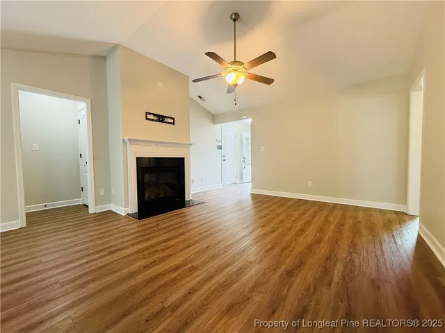 wooden floor in an empty room with a fireplace