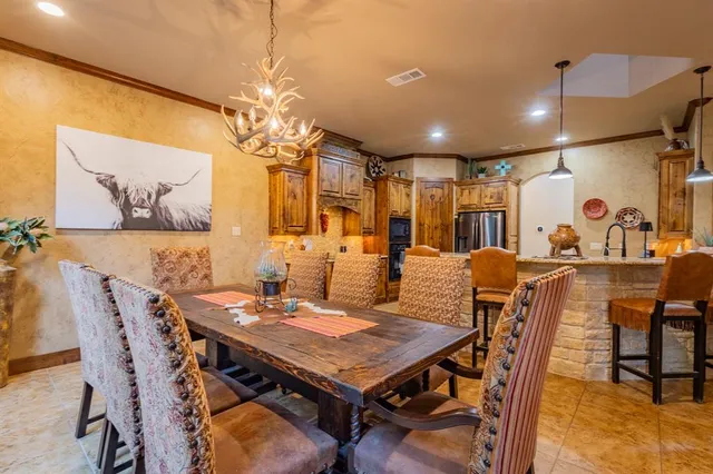 a view of a dining room with furniture and chandelier