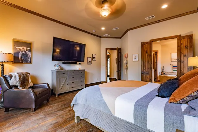 a bedroom with furniture and a flat screen tv