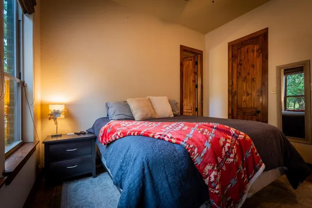 a bedroom with a bed and a window