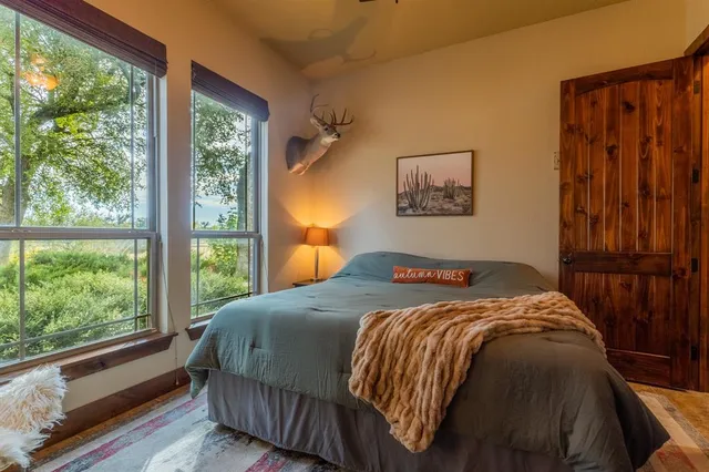a bed sitting in a bedroom next to a window