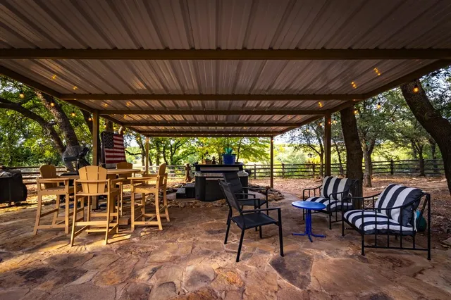 a view of a patio with table and chairs
