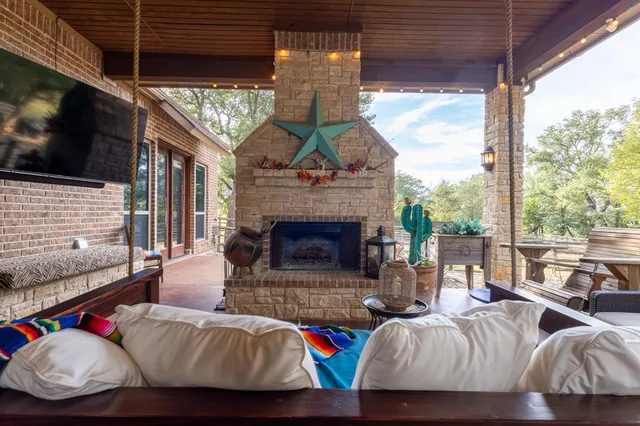 a living room with furniture fireplace and flat screen tv