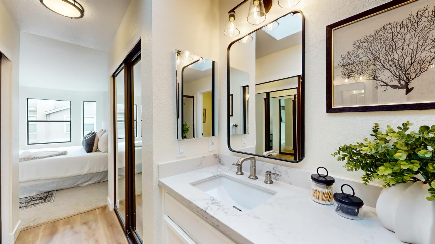994 La Mesa Terrace, Unit E Sunnyvale, CA 94086 - Photo 13 of 28 a bathroom with a sink mirror and vanity