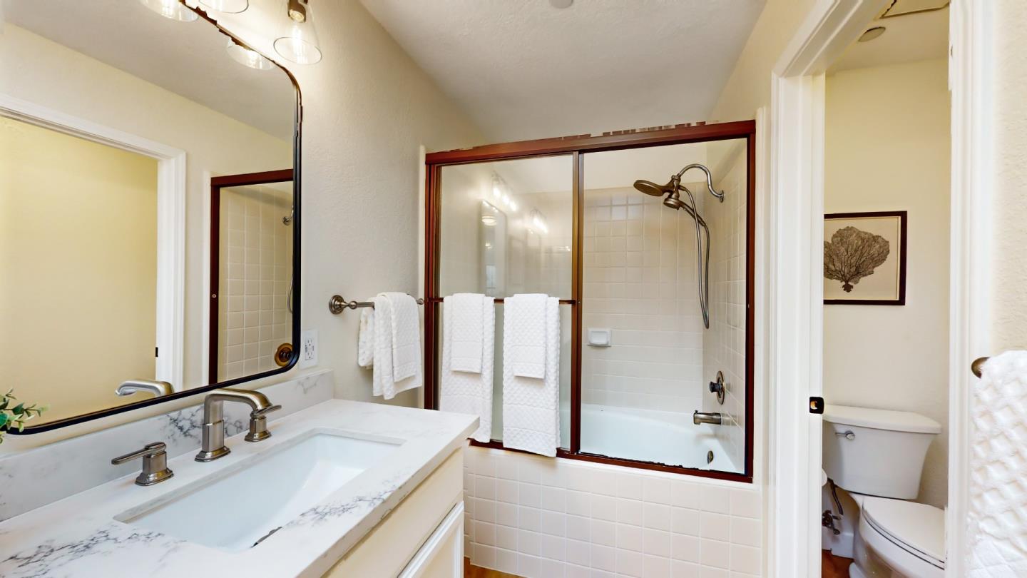 994 La Mesa Terrace, Unit E Sunnyvale, CA 94086 - Photo 15 of 28 a bathroom with a granite countertop shower sink and mirror