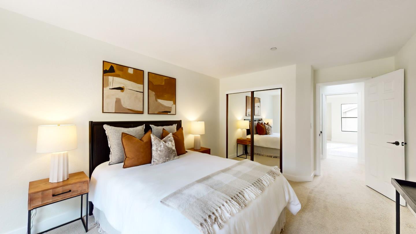 994 La Mesa Terrace, Unit E Sunnyvale, CA 94086 - Photo 16 of 28 a bedroom with a bed and a lamp