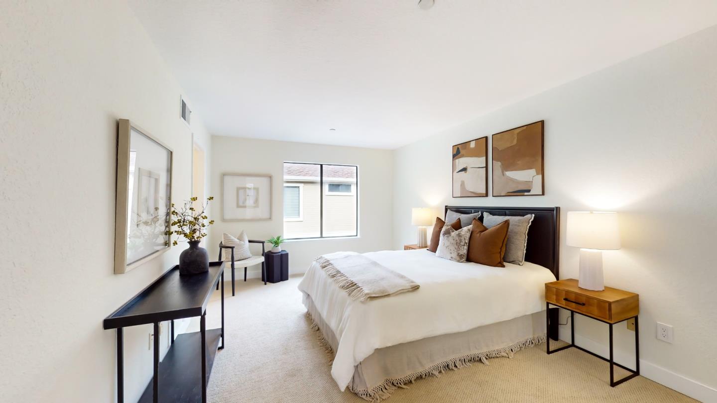 994 La Mesa Terrace, Unit E Sunnyvale, CA 94086 - Photo 17 of 28 a bedroom with a bed and wooden floor