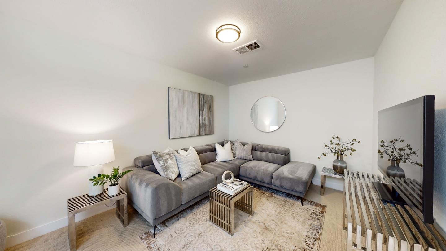 994 La Mesa Terrace, Unit E Sunnyvale, CA 94086 - Photo 20 of 28 a living room with furniture and a flat screen tv