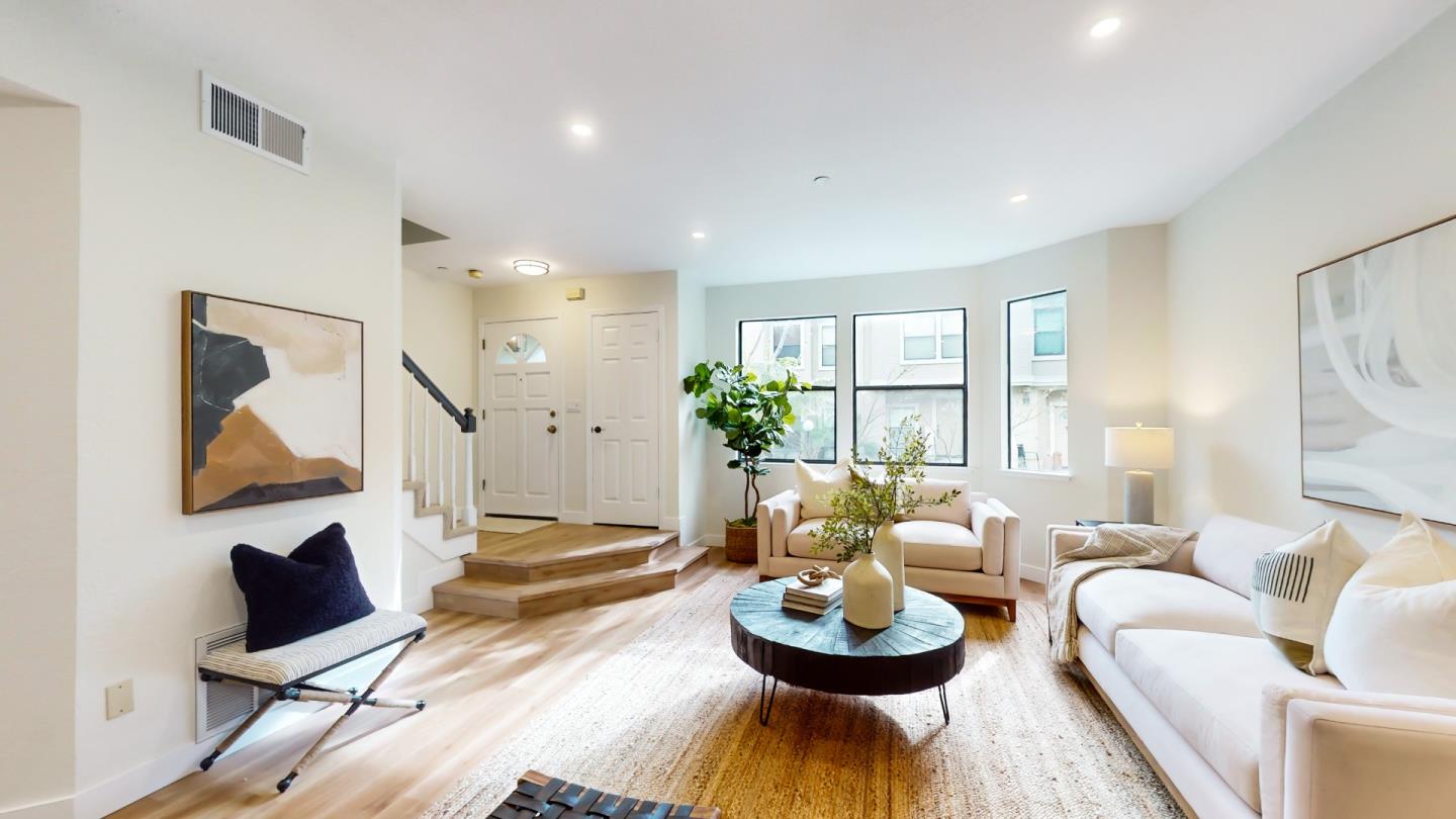 994 La Mesa Terrace, Unit E Sunnyvale, CA 94086 - Photo 2 of 28 a living room with furniture and a potted plant