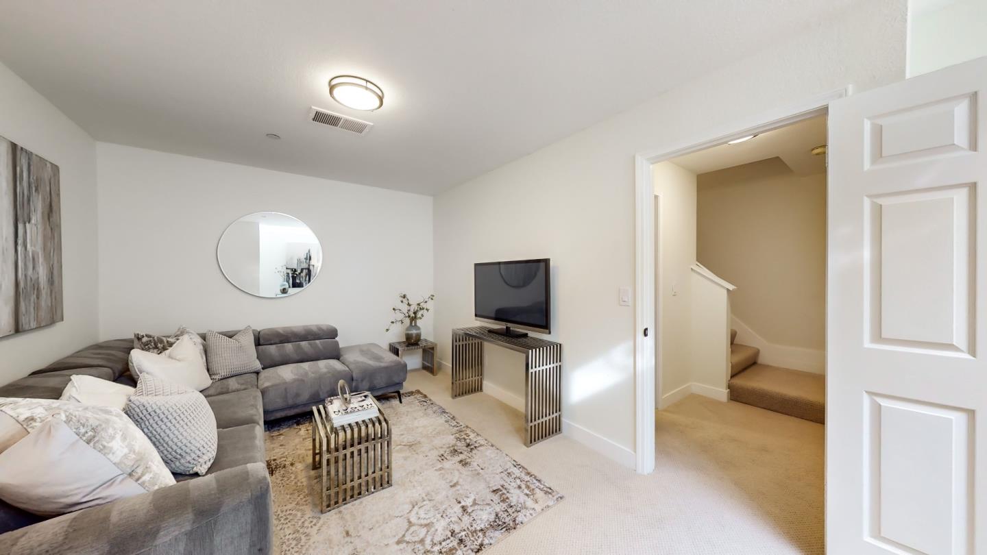994 La Mesa Terrace, Unit E Sunnyvale, CA 94086 - Photo 21 of 28 a living room with furniture and a flat screen tv