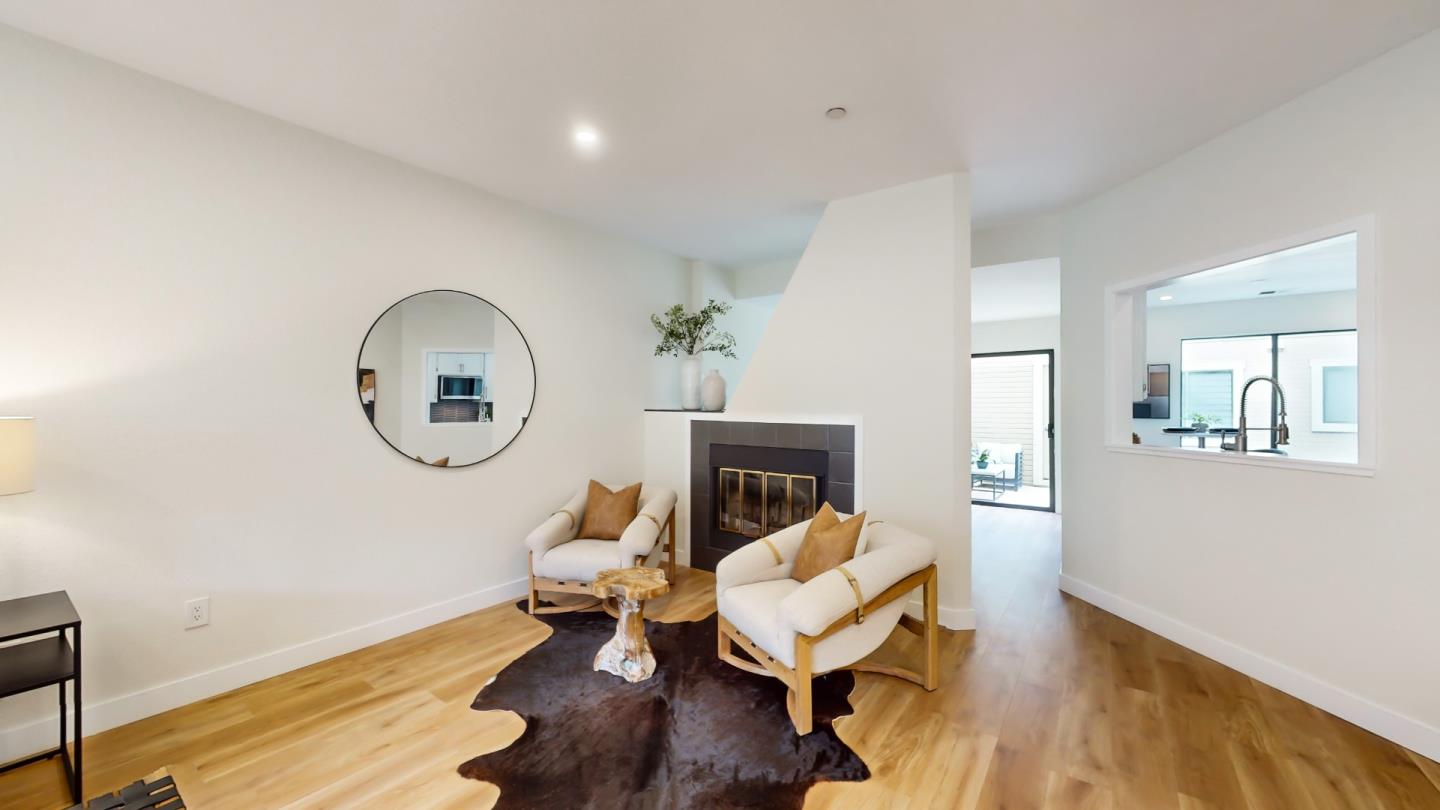 994 La Mesa Terrace, Unit E Sunnyvale, CA 94086 - Photo 5 of 28 a living room with fireplace furniture and a wooden floor