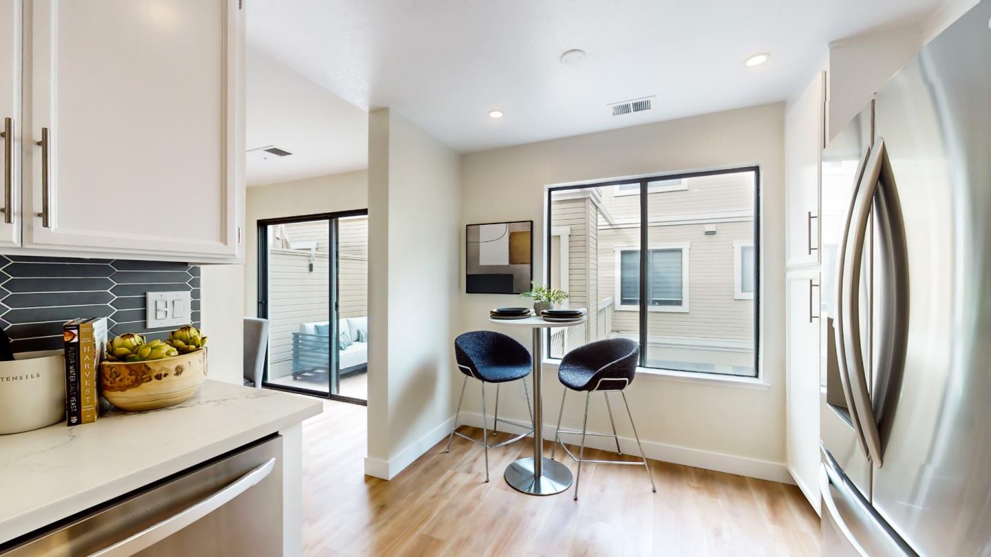 994 La Mesa Terrace, Unit E Sunnyvale, CA 94086 - Photo 9 of 28 a kitchen with stainless steel appliances granite countertop a refrigerator a stove and a sink
