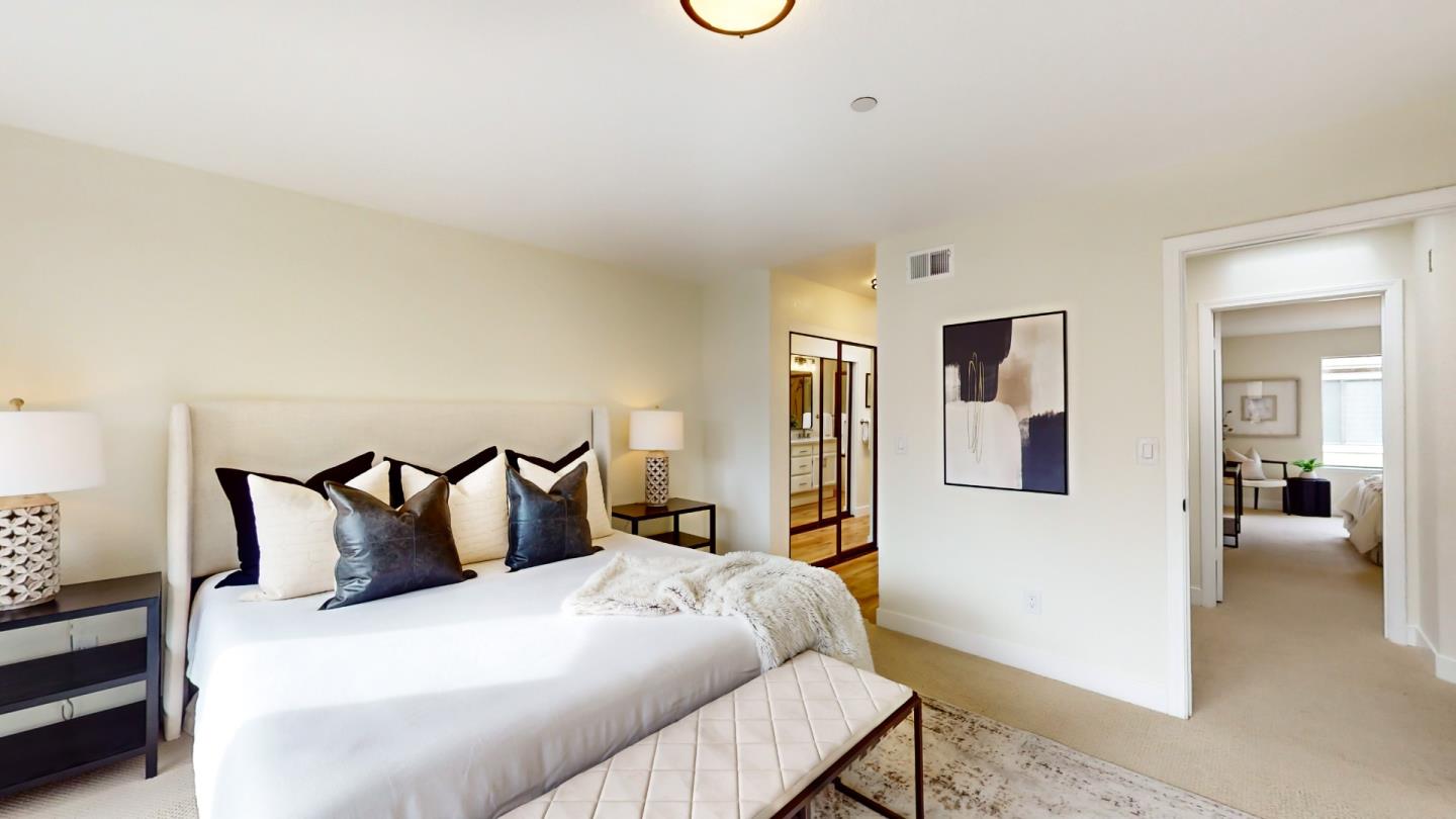 994 La Mesa Terrace, Unit E Sunnyvale, CA 94086 - Photo 10 of 28 a bedroom with a bed and a mirror